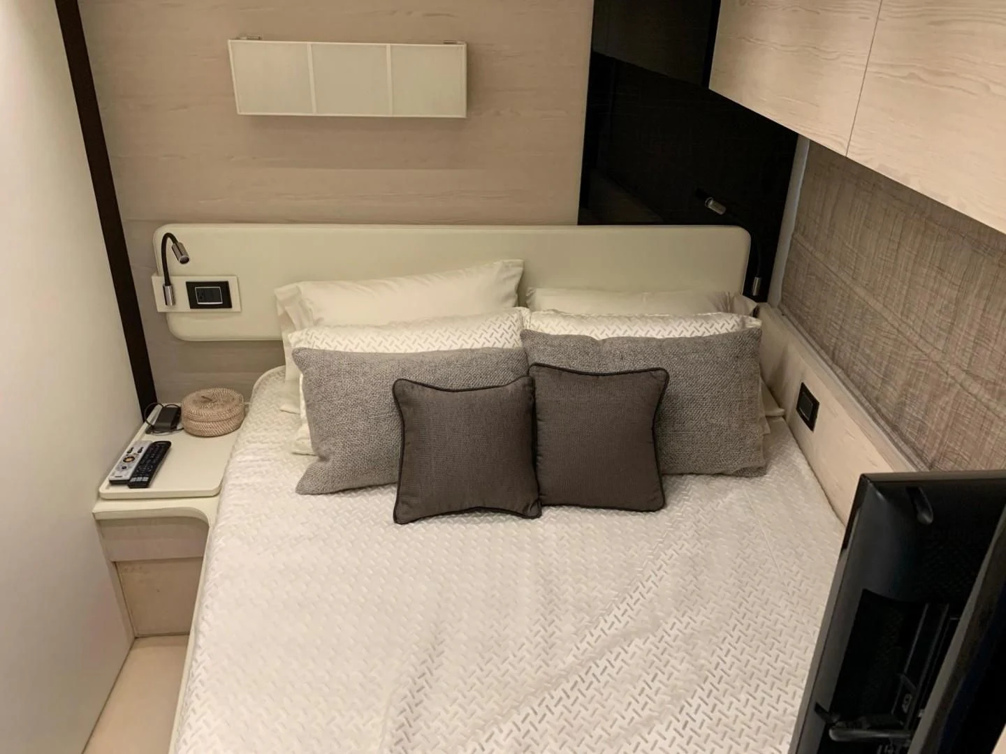 a bed with pillows and a phone aboard AMALFI Yacht for Sale