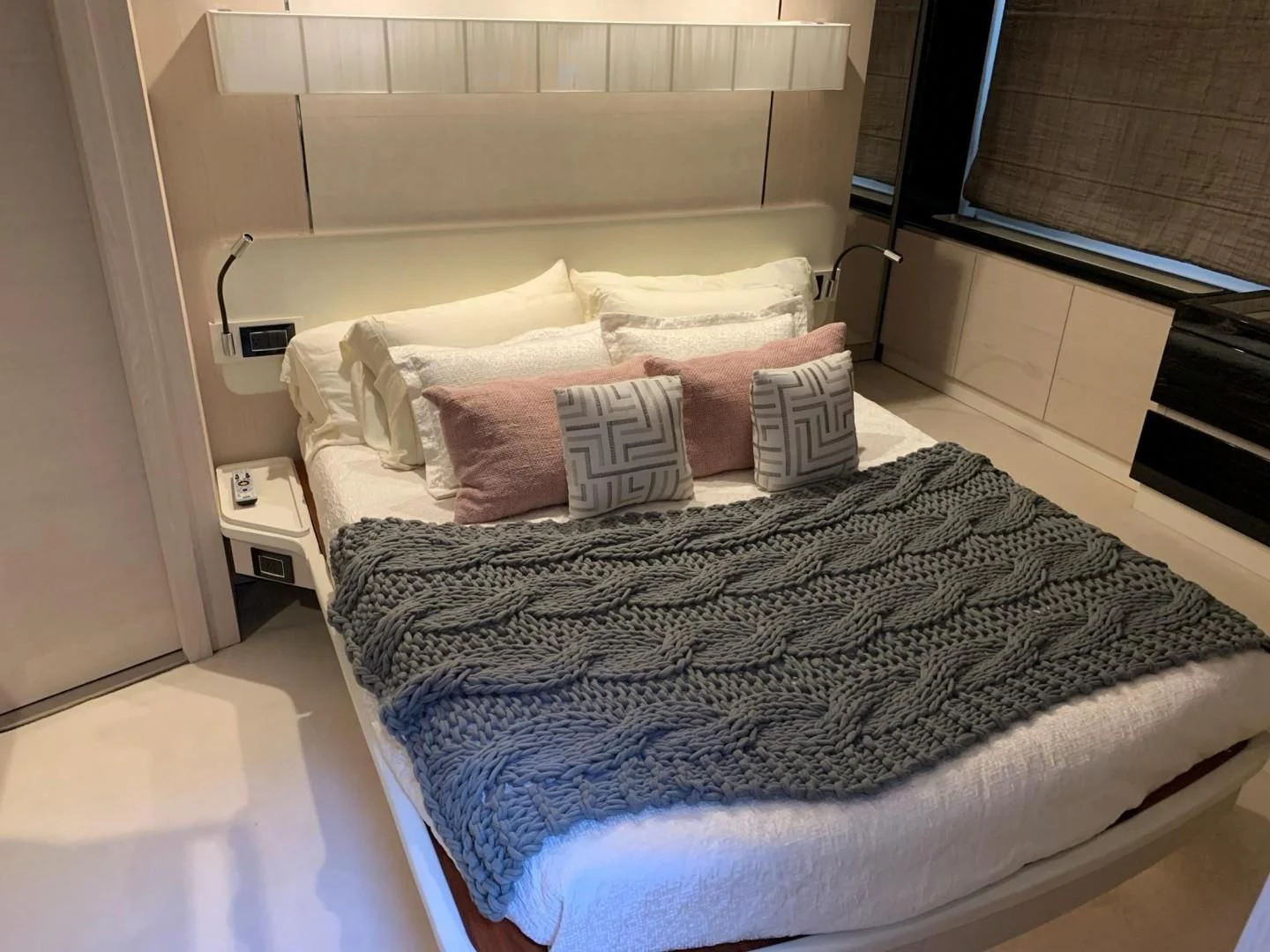 a bed with a white comforter and pillows aboard AMALFI Yacht for Sale