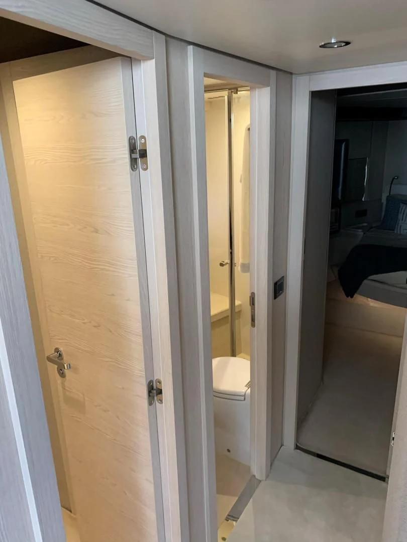 a white door with a white wall aboard AMALFI Yacht for Sale