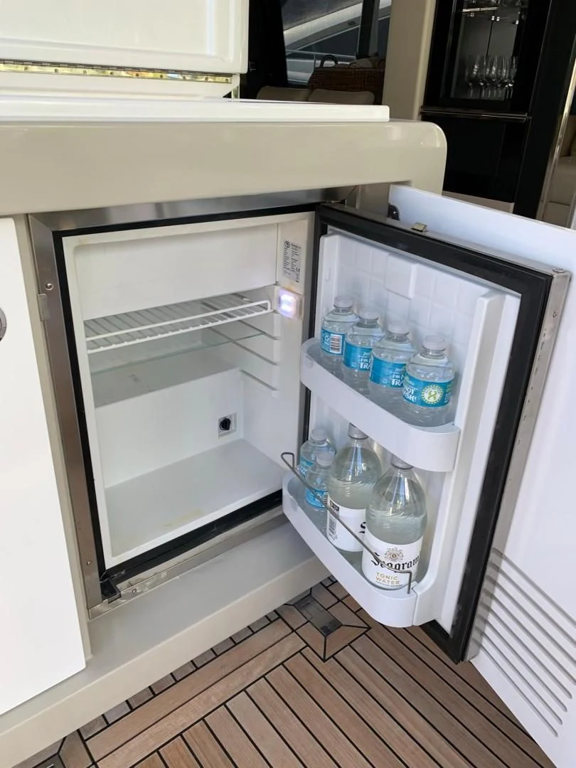 a refrigerator with water bottles aboard AMALFI Yacht for Sale