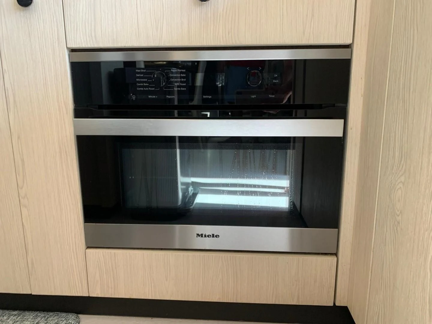 a microwave oven in a wooden cabinet aboard AMALFI Yacht for Sale