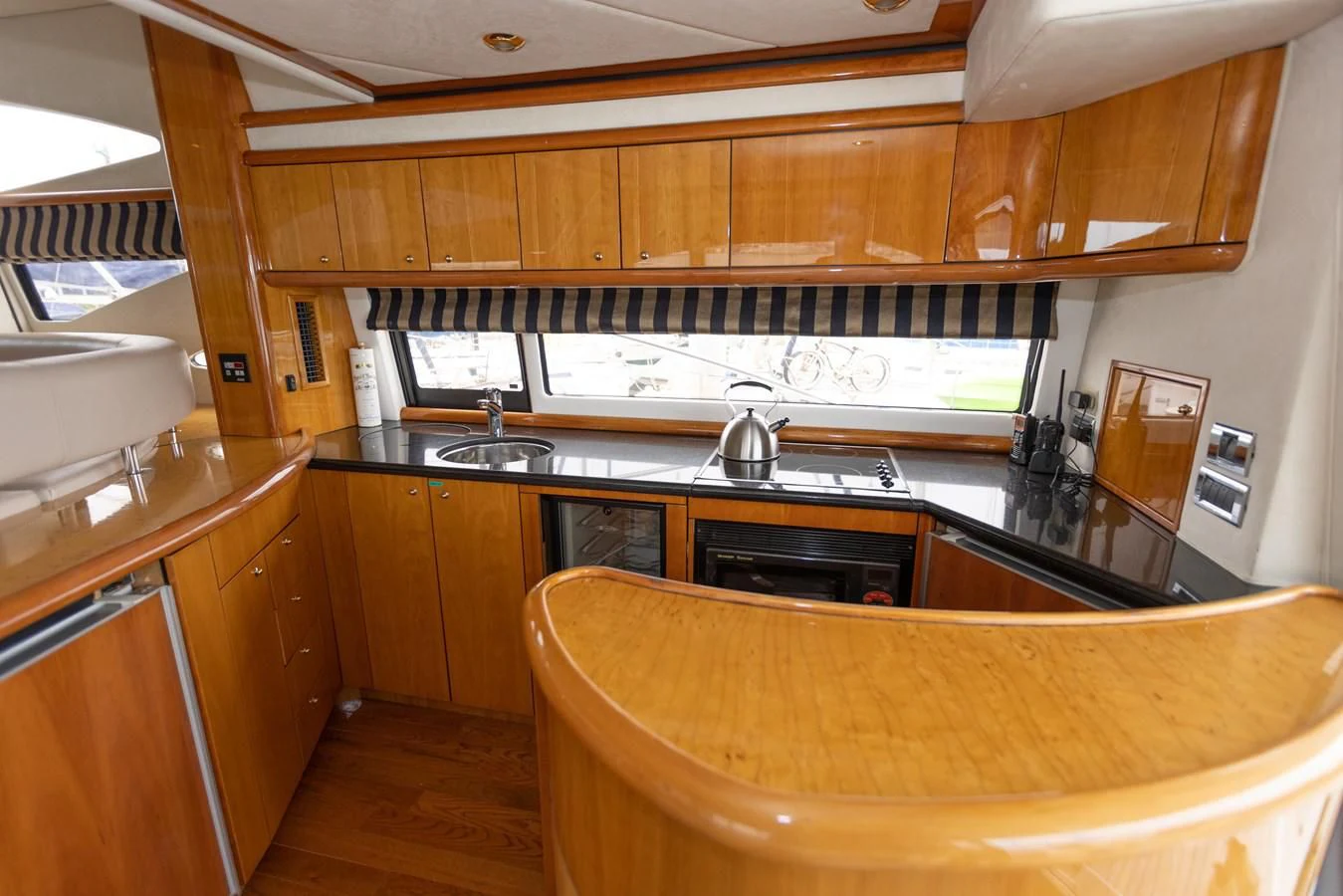 a kitchen with wooden cabinets aboard BIG DREAM Yacht for Sale