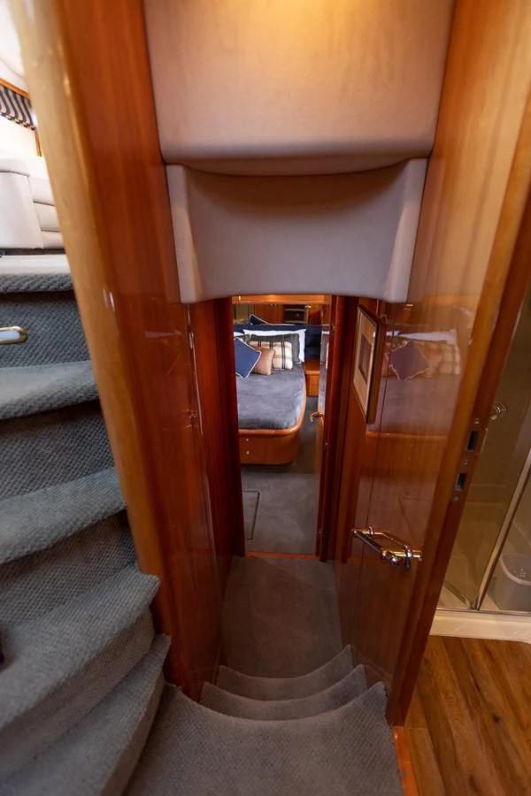 a wooden staircase with a glass door aboard BIG DREAM Yacht for Sale