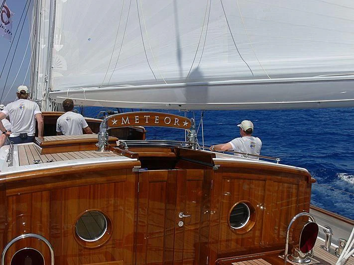 a boat with people sitting on it aboard METEOR Yacht for Sale