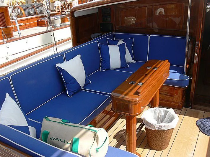 a boat with a table and chairs aboard METEOR Yacht for Sale