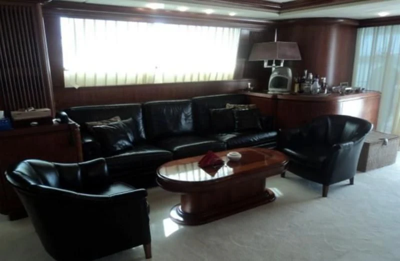 a living room with leather couches aboard ELMAR Yacht for Sale