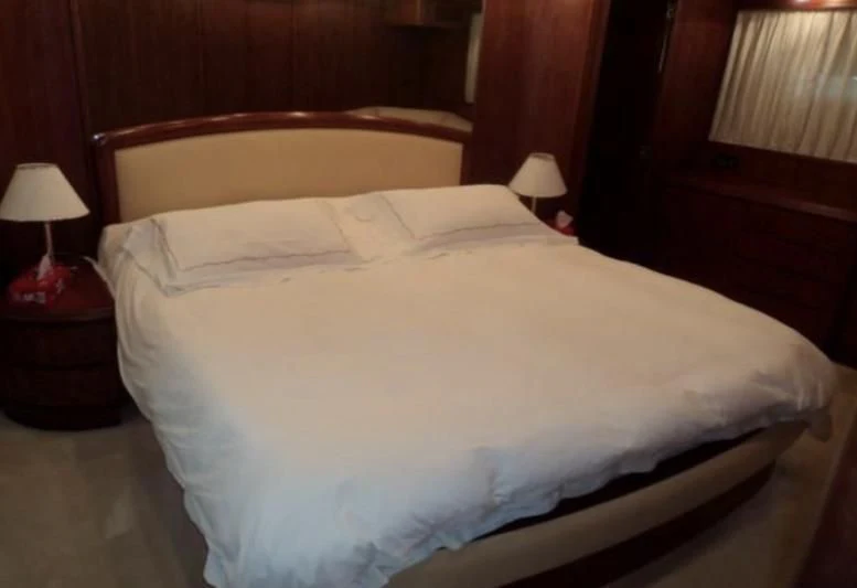 a bed with white sheets aboard ELMAR Yacht for Sale