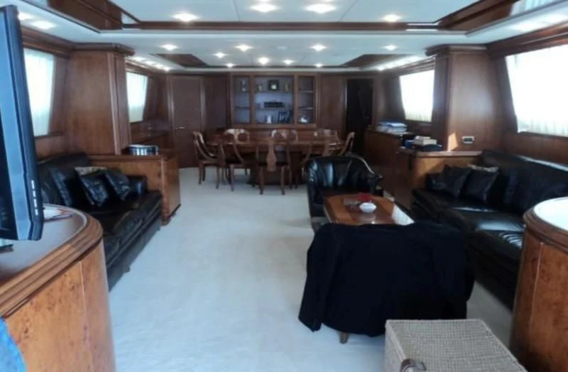 a room with a couch and a table and chairs aboard ELMAR Yacht for Sale