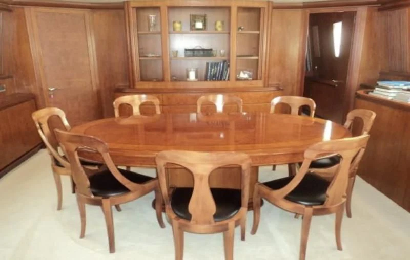 a table with chairs around it aboard ELMAR Yacht for Sale