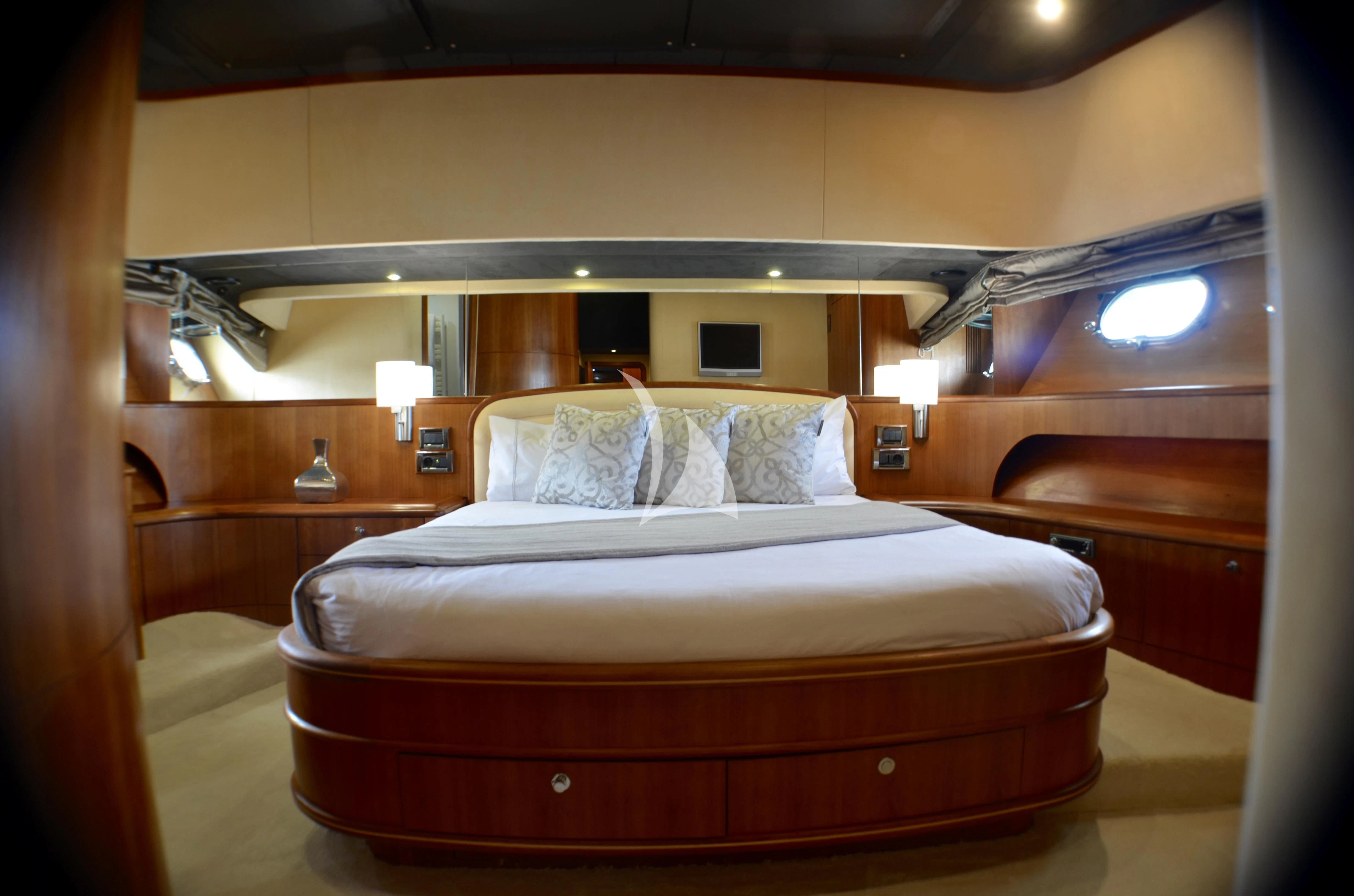 a bed with a wooden headboard aboard FIGI Yacht for Sale