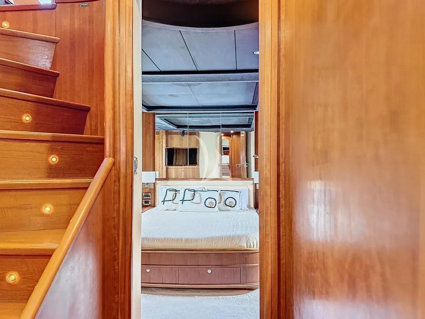a room with a bed and a dresser aboard FIGI Yacht for Sale