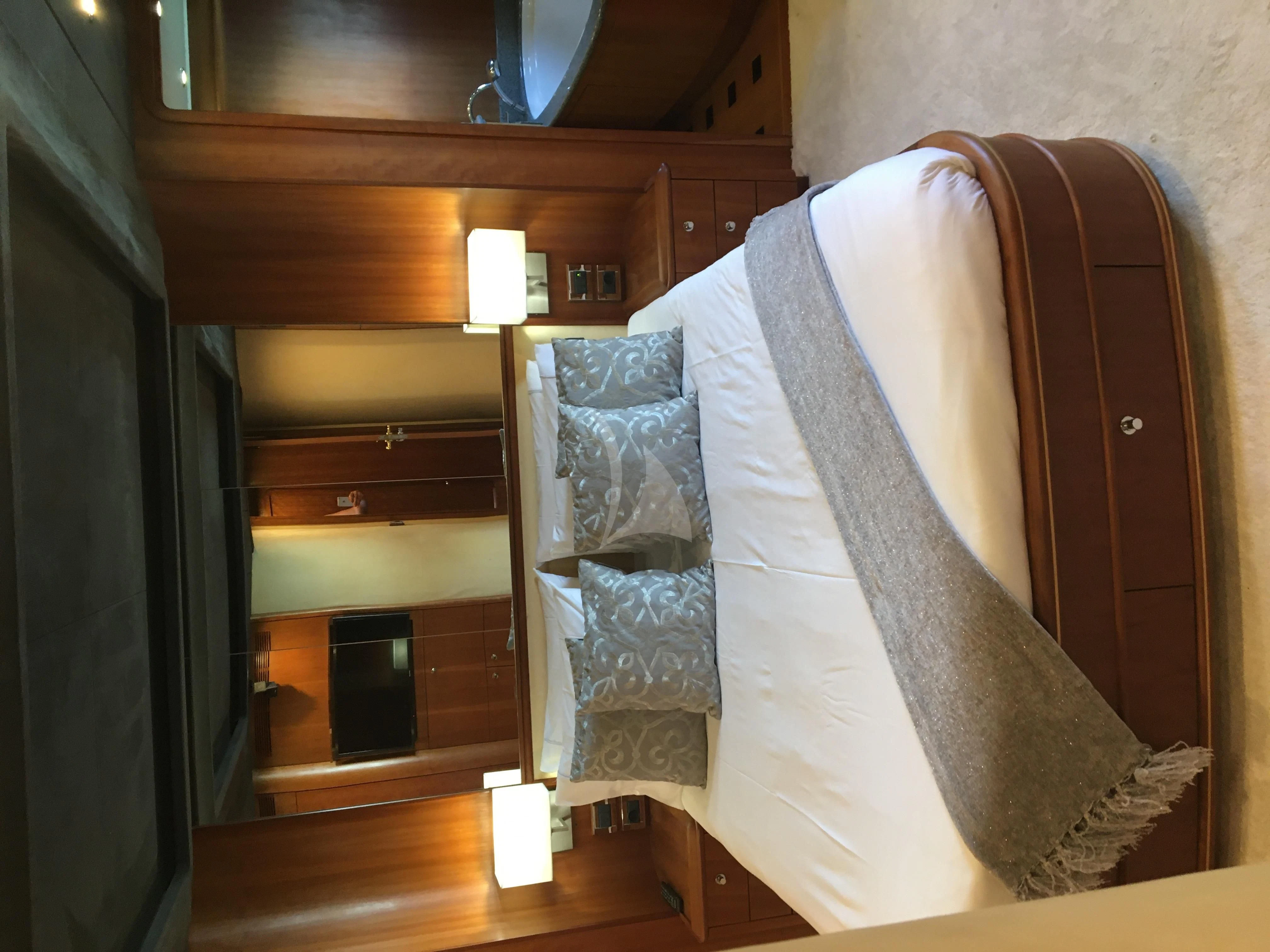 a closet with clothes on the wall aboard FIGI Yacht for Sale