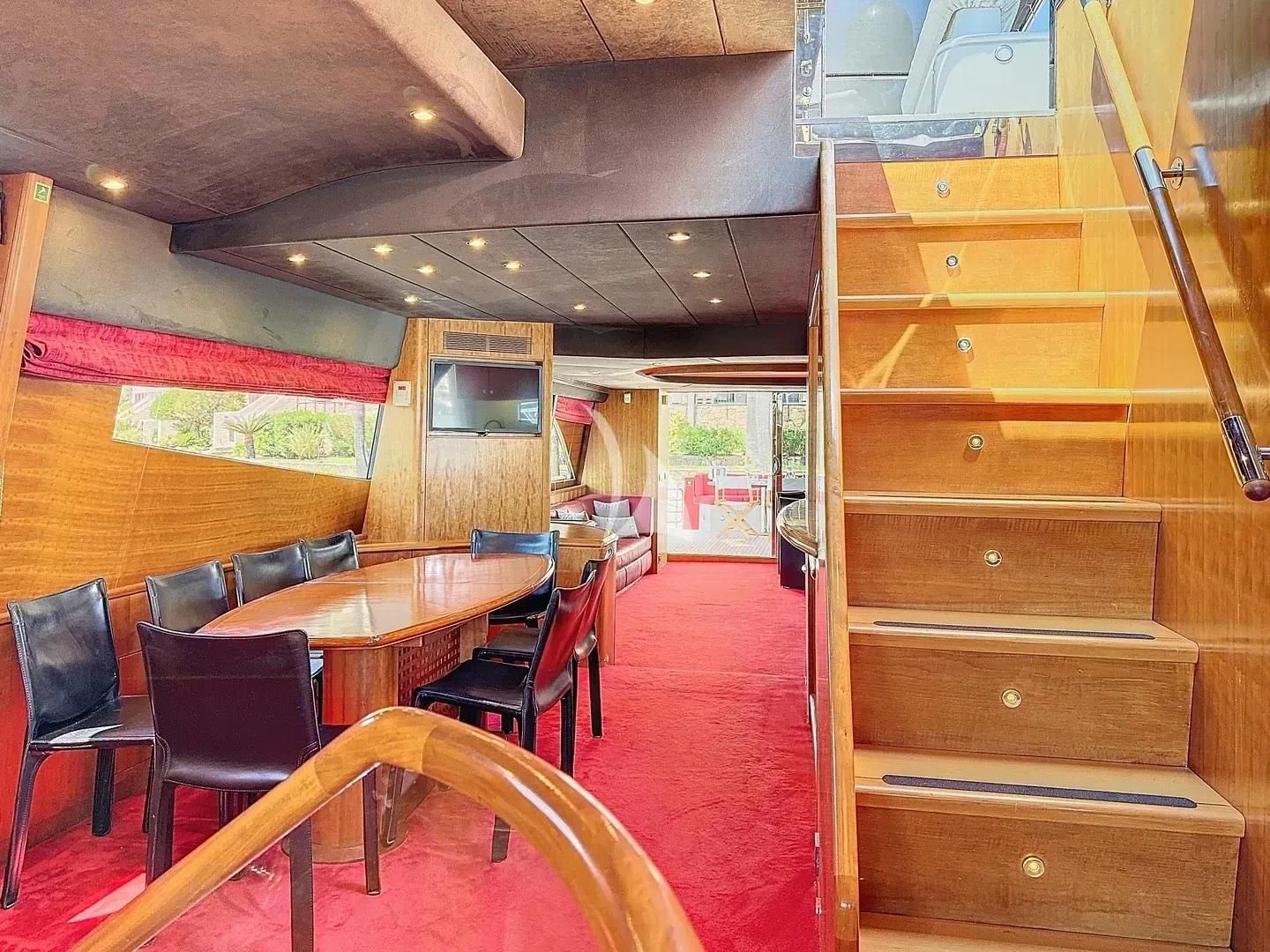 a room with tables and chairs aboard FIGI Yacht for Sale