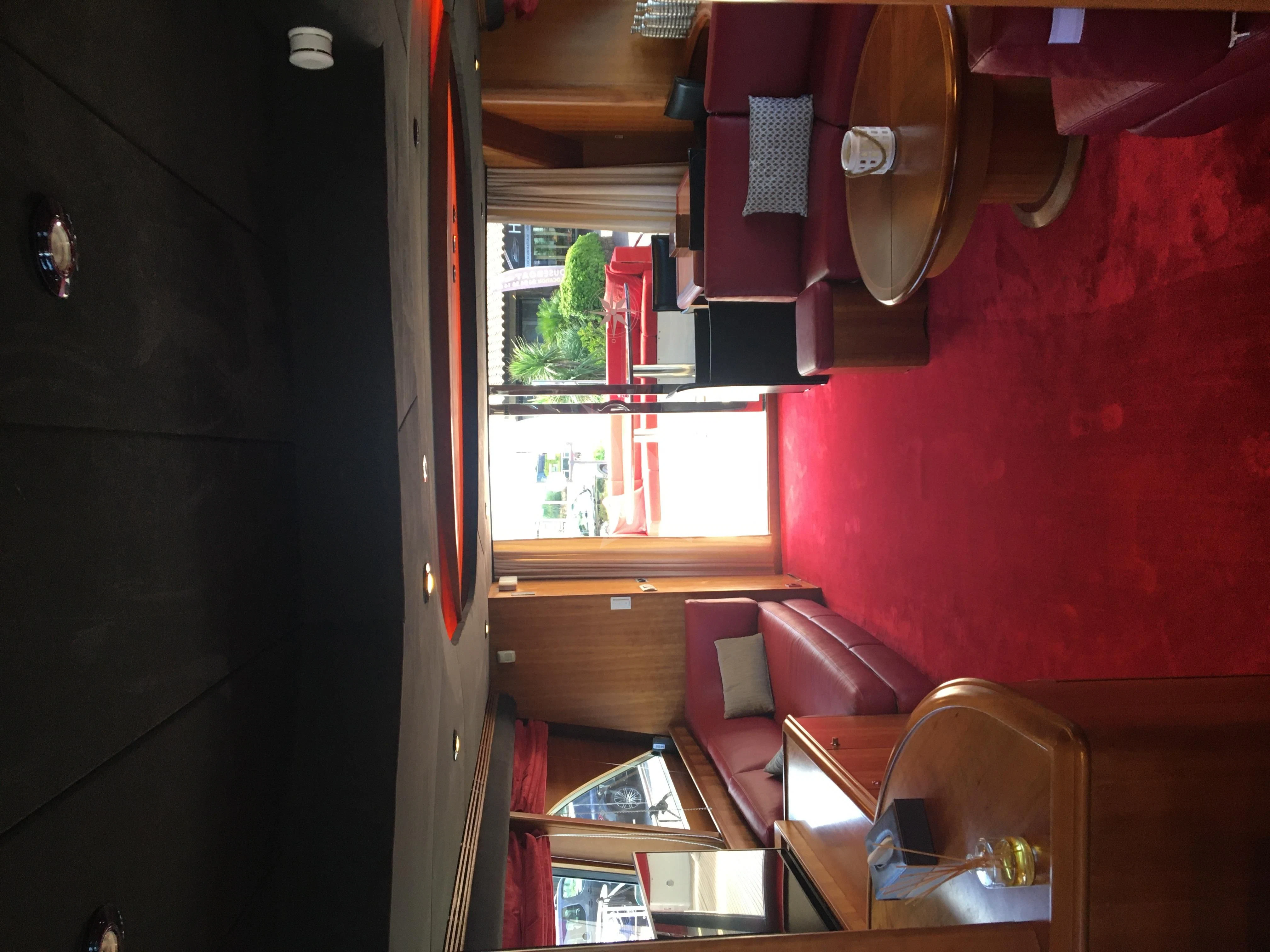 a room with a chair and a table and chairs aboard FIGI Yacht for Sale