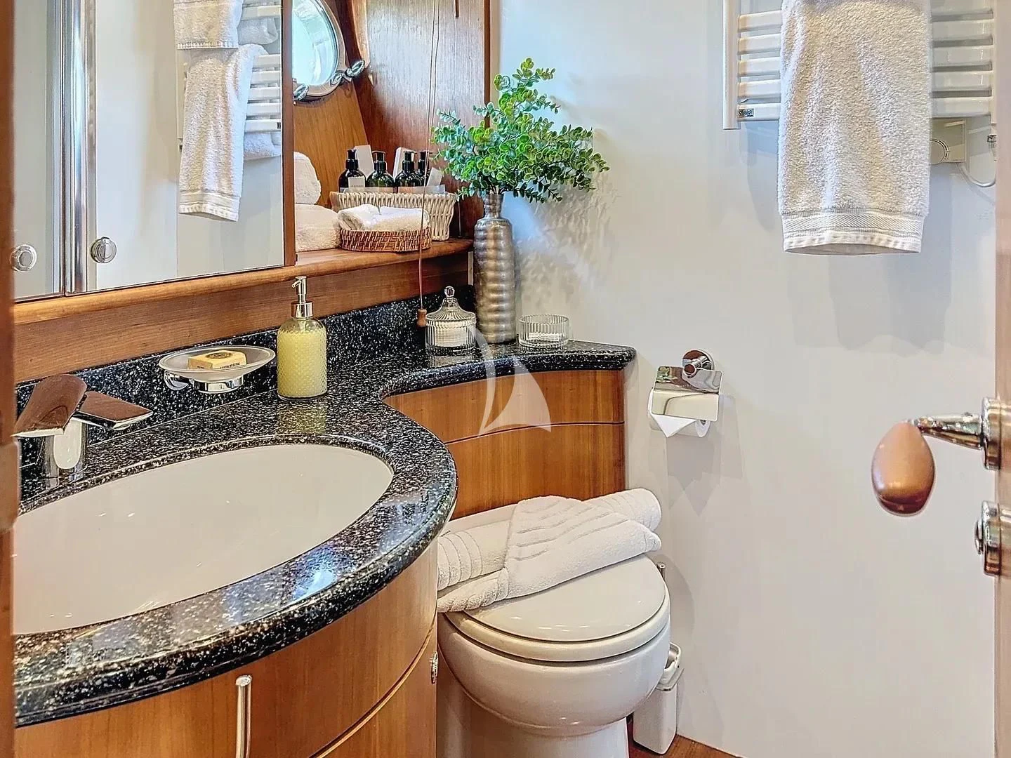 a bathroom with a sink toilet and towels aboard FIGI Yacht for Sale