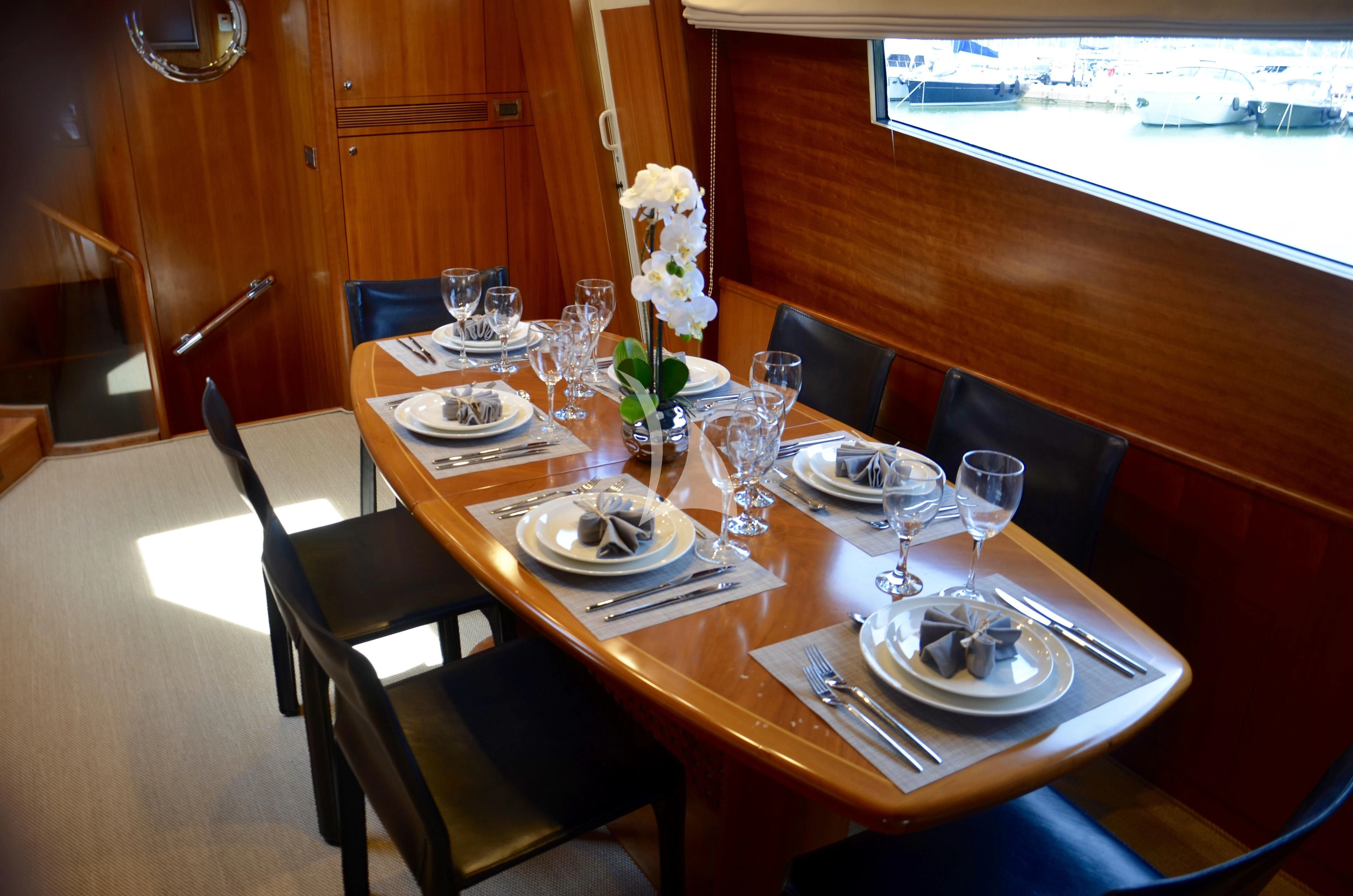 a table set with plates and glasses aboard FIGI Yacht for Sale