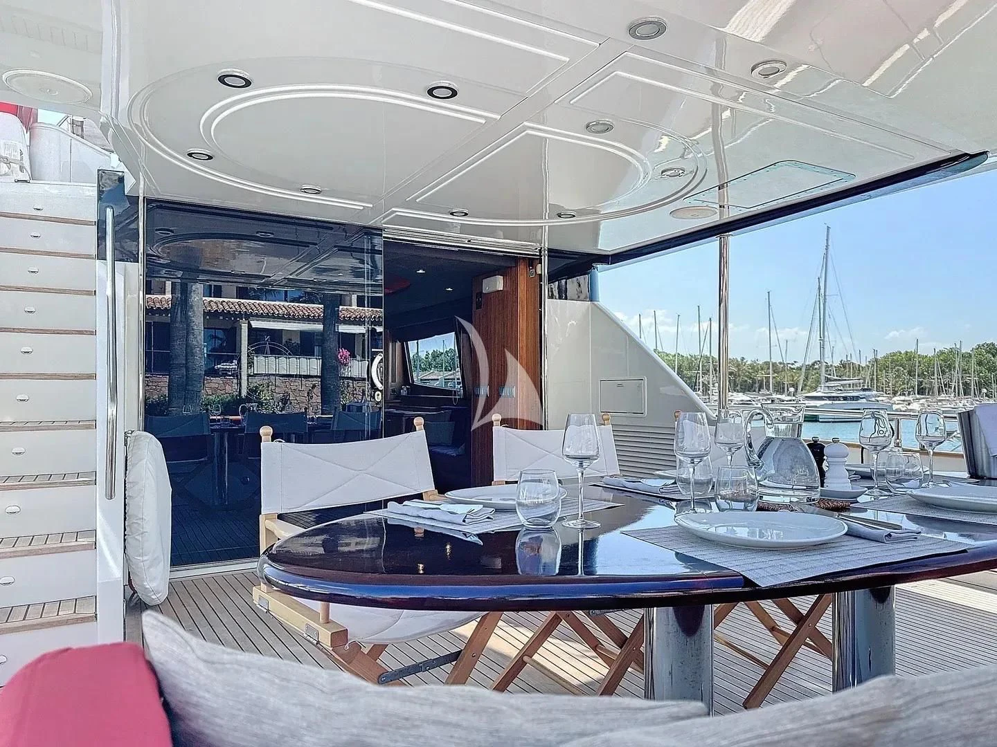 a table with chairs and a large window aboard FIGI Yacht for Sale