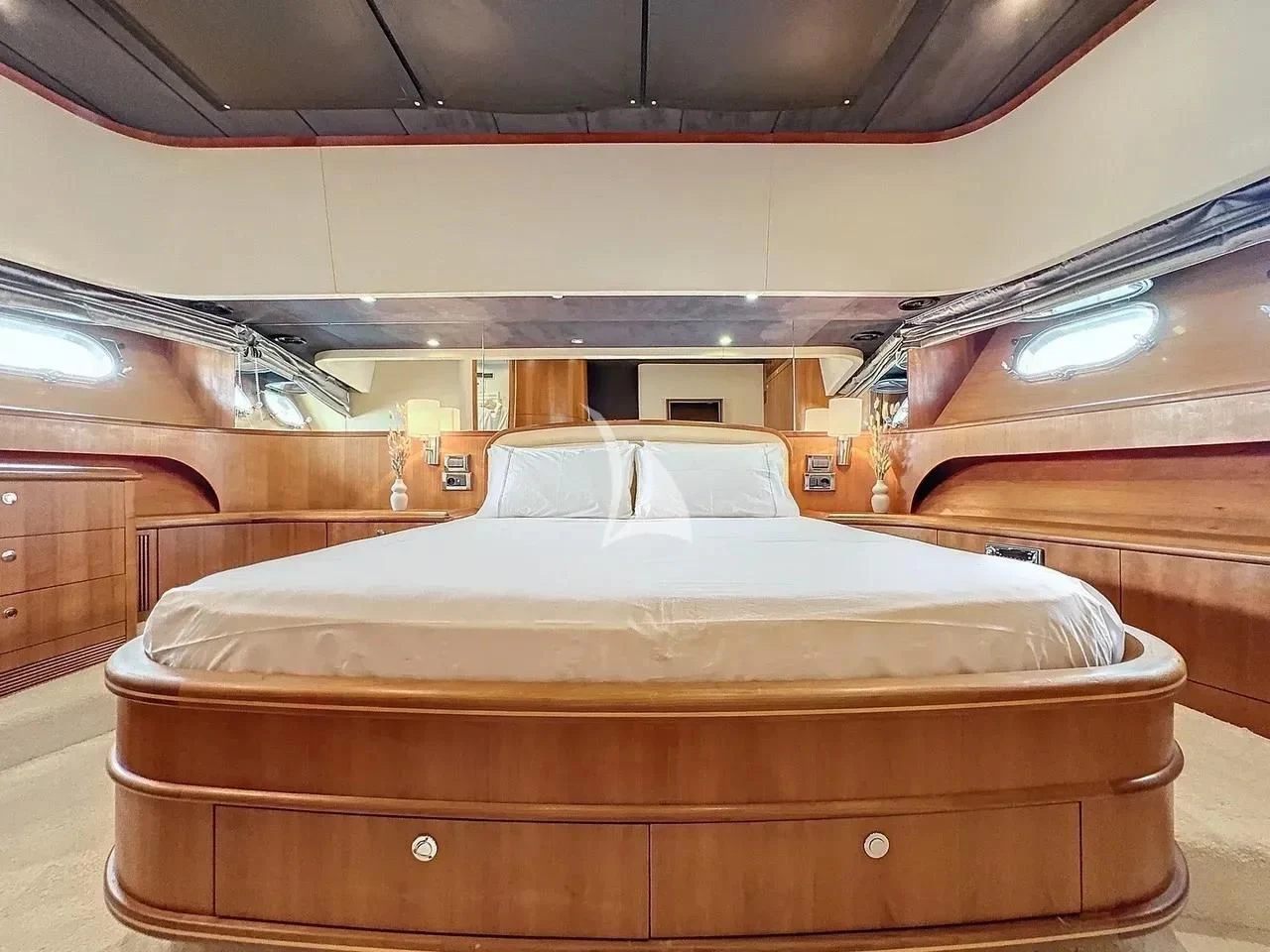a room with a bed and a wood cabinet aboard FIGI Yacht for Sale