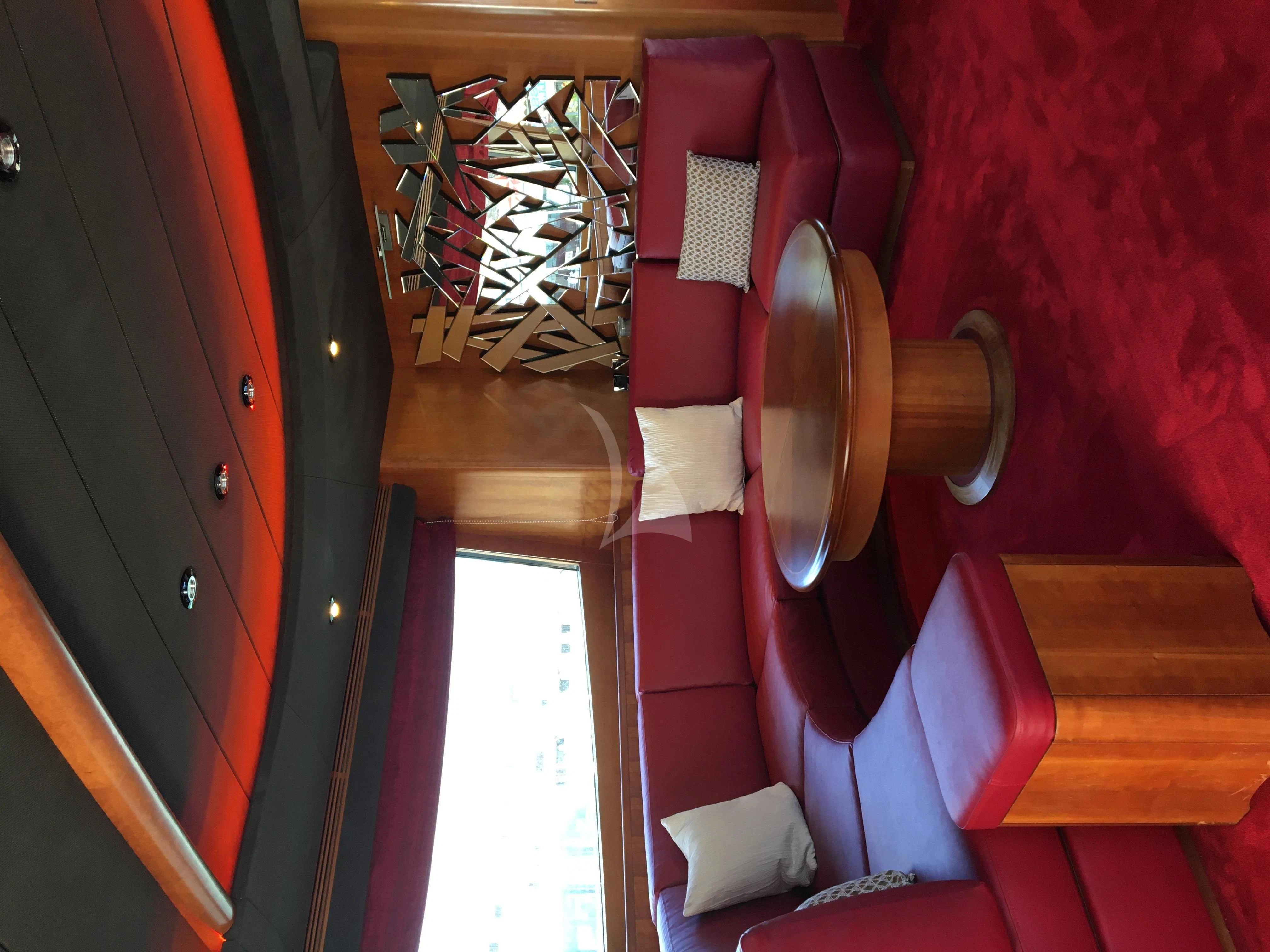 a room with red walls and a door with a wood door and a window with a red wall aboard FIGI Yacht for Sale