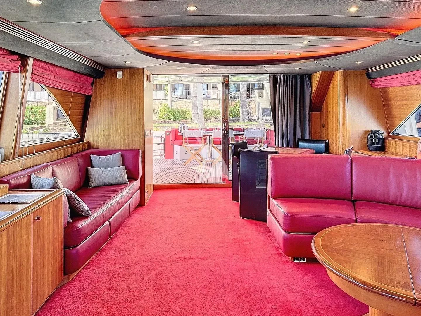 a living room with a red rug aboard FIGI Yacht for Sale