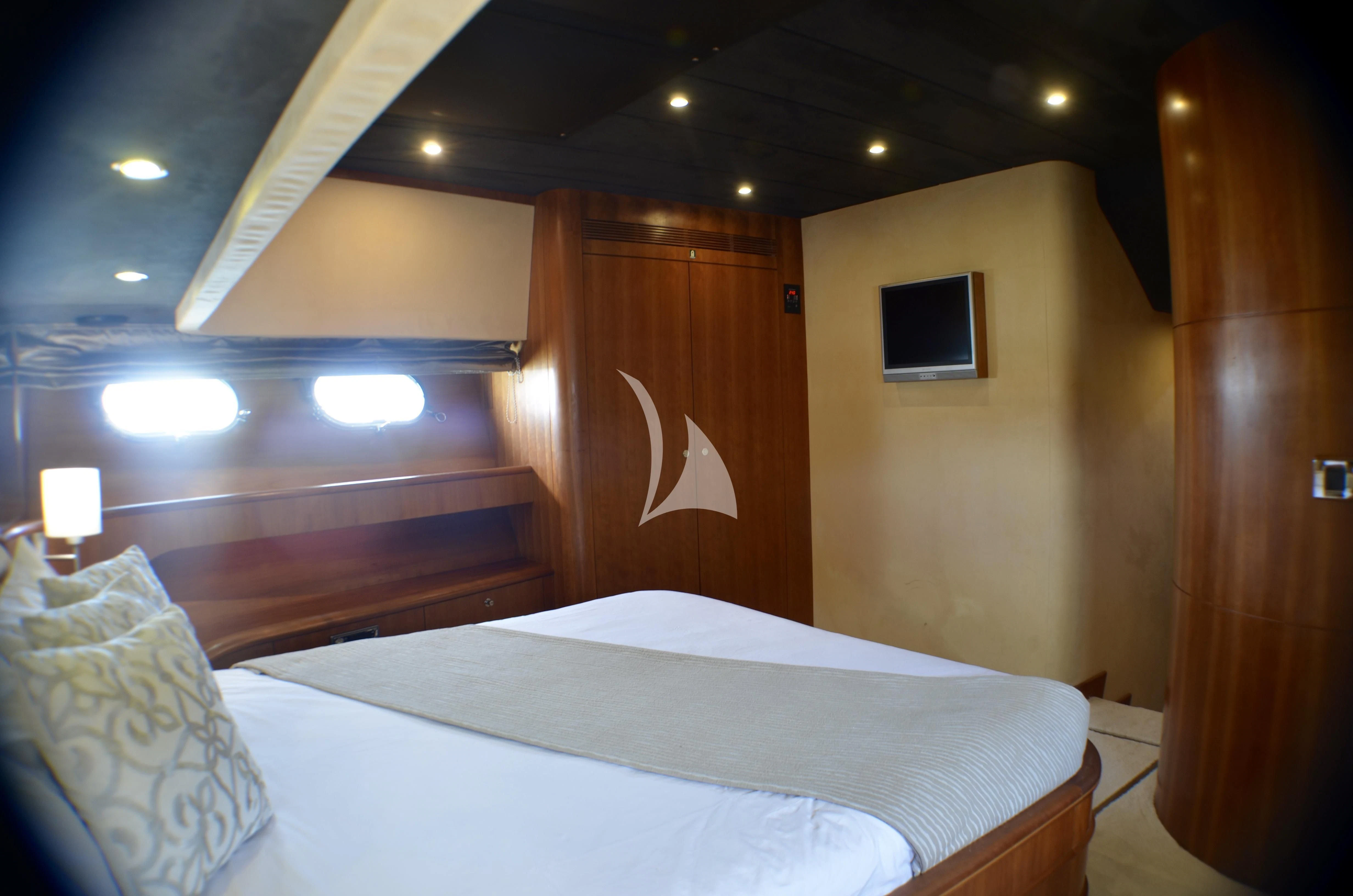 a room with a bed and a wood door aboard FIGI Yacht for Sale