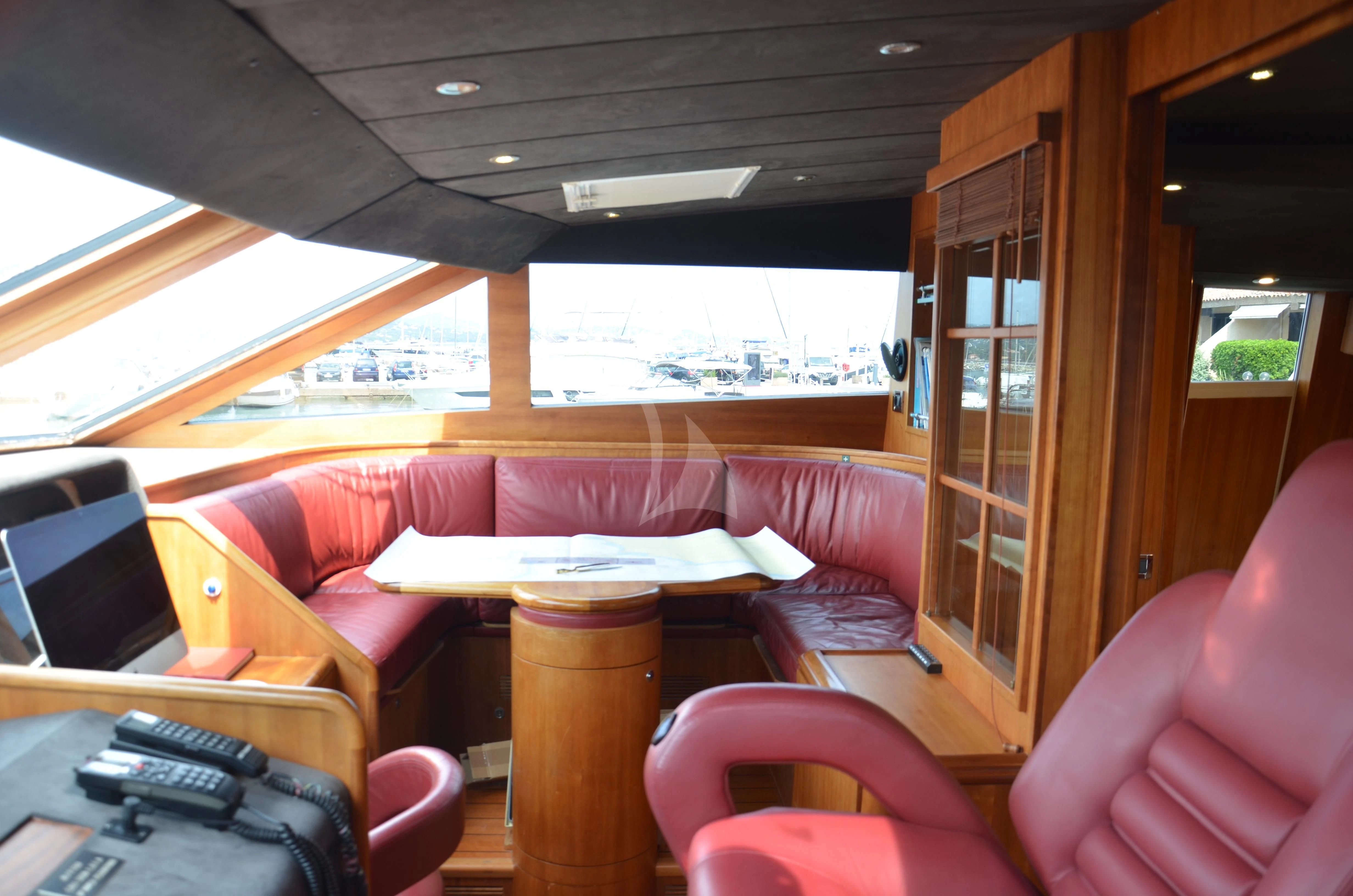 a boat with a table and chairs aboard FIGI Yacht for Sale