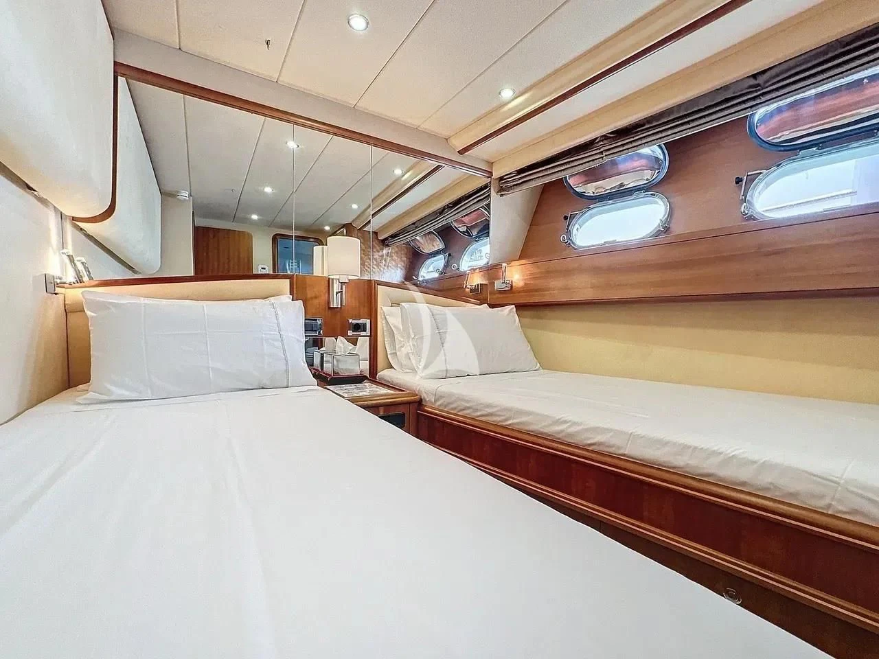 a room with a bed and a window aboard FIGI Yacht for Sale