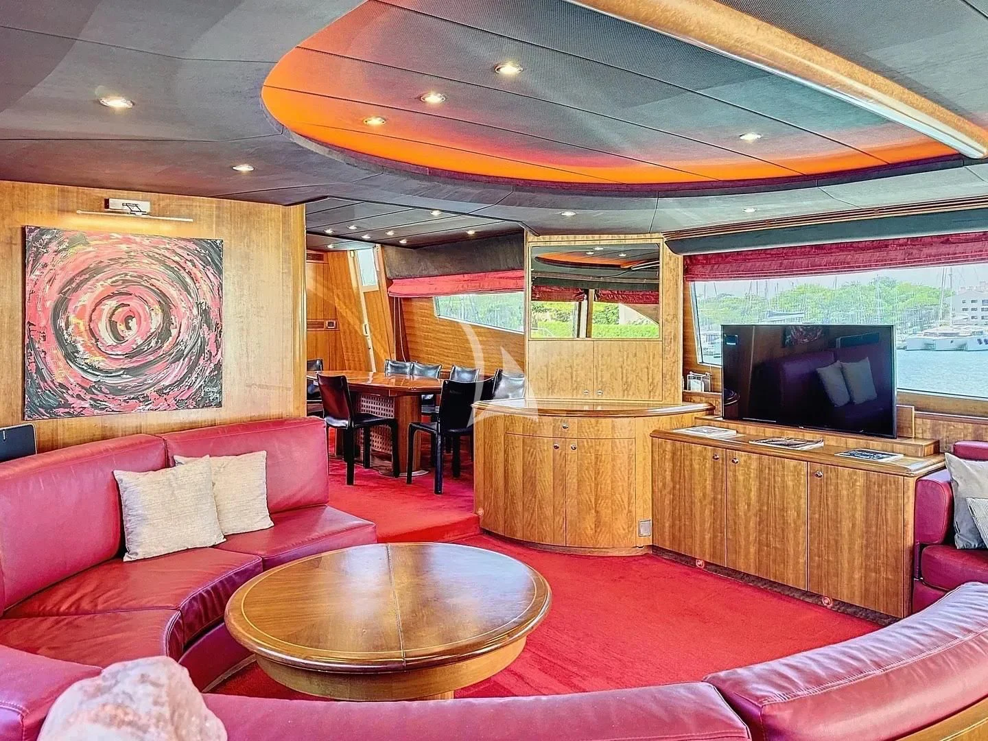 a living room with a tv and furniture aboard FIGI Yacht for Sale