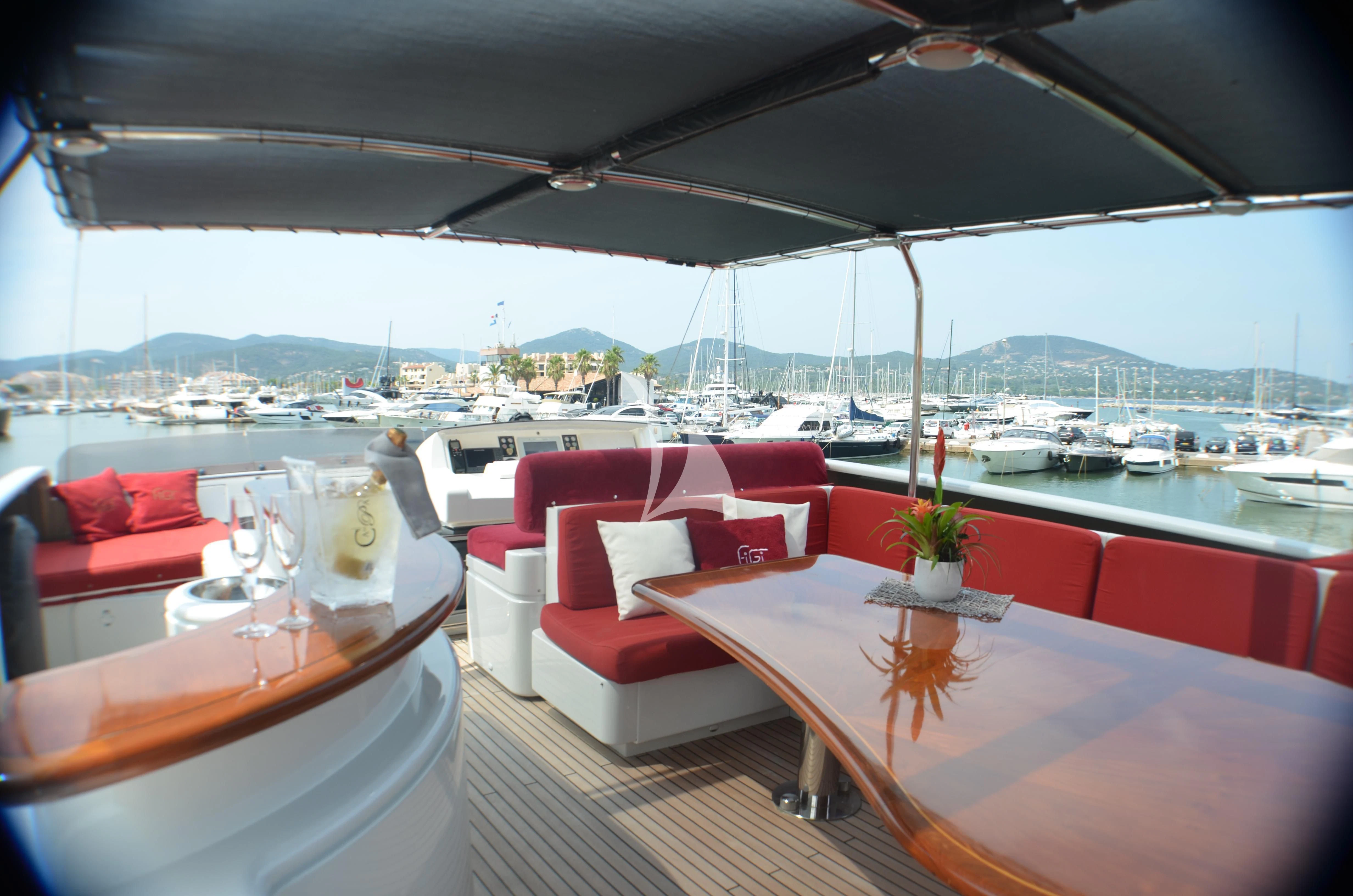 a room with tables and chairs aboard FIGI Yacht for Sale