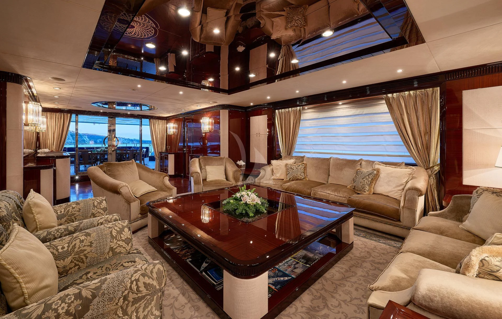 a living room with a table and couches aboard REVE D'OR Yacht for Sale