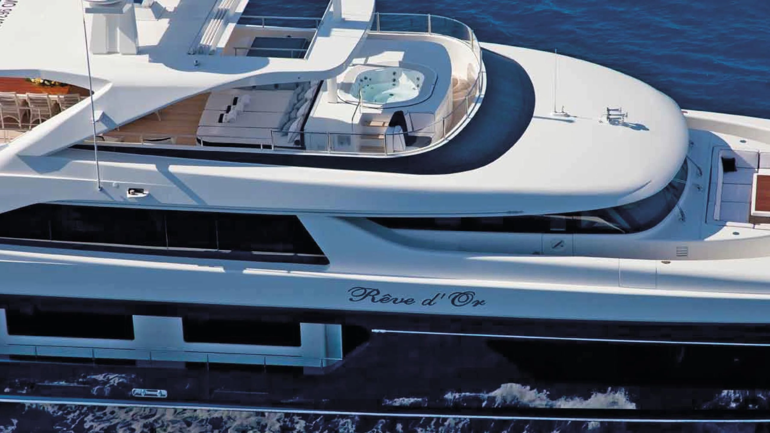 a white yacht on a dock aboard REVE D'OR Yacht for Sale