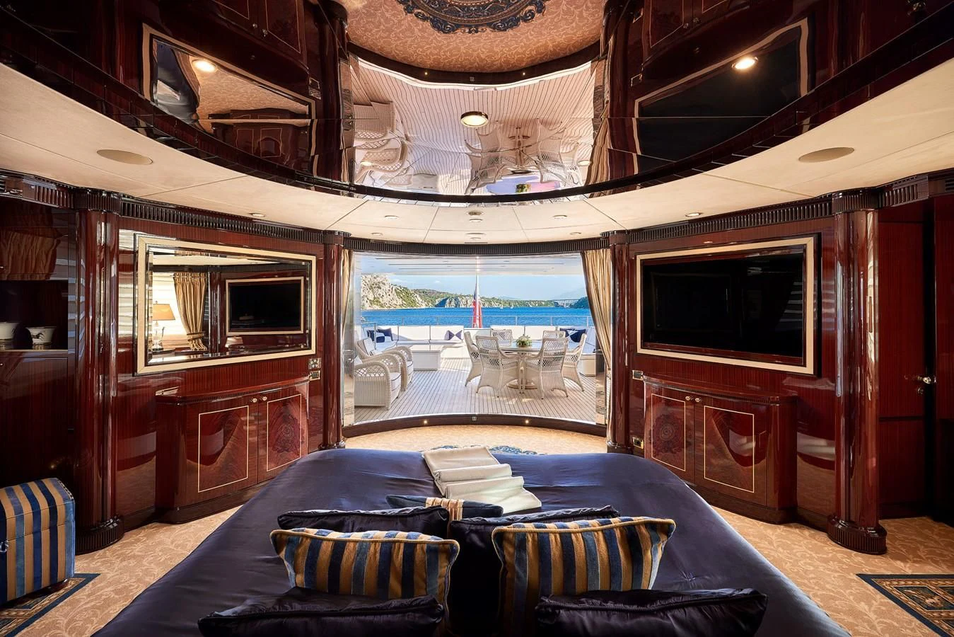 a bedroom with a bed and a television aboard REVE D'OR Yacht for Sale