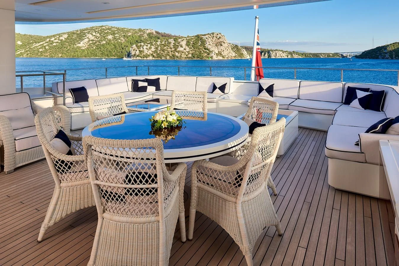 a table and chairs on a patio aboard REVE D'OR Yacht for Sale
