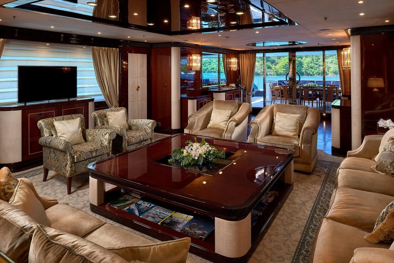 a living room with a table and couches aboard REVE D'OR Yacht for Sale