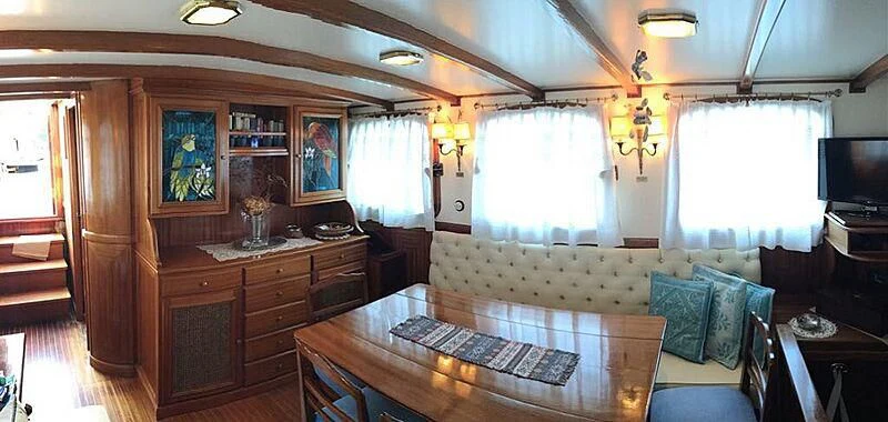 a living room with a couch and a table aboard LA VAGABUNDA Yacht for Sale