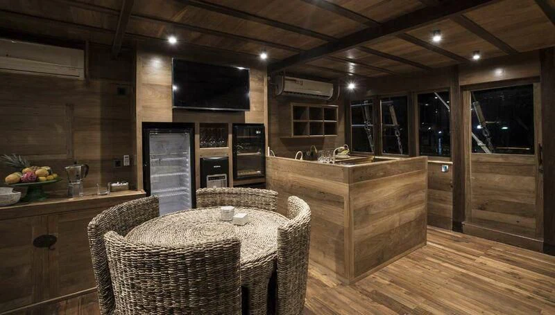 a kitchen with a table and chairs aboard TIARE Yacht for Sale