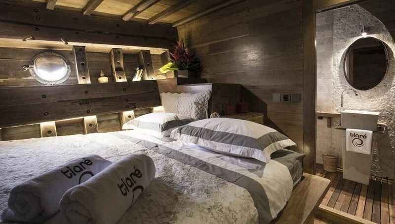 a bed in a room aboard TIARE Yacht for Sale
