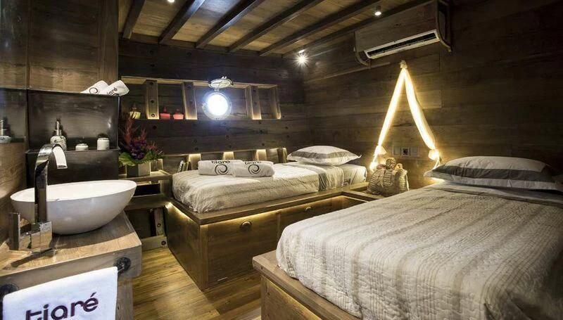 a room with a bed and a sink aboard TIARE Yacht for Sale