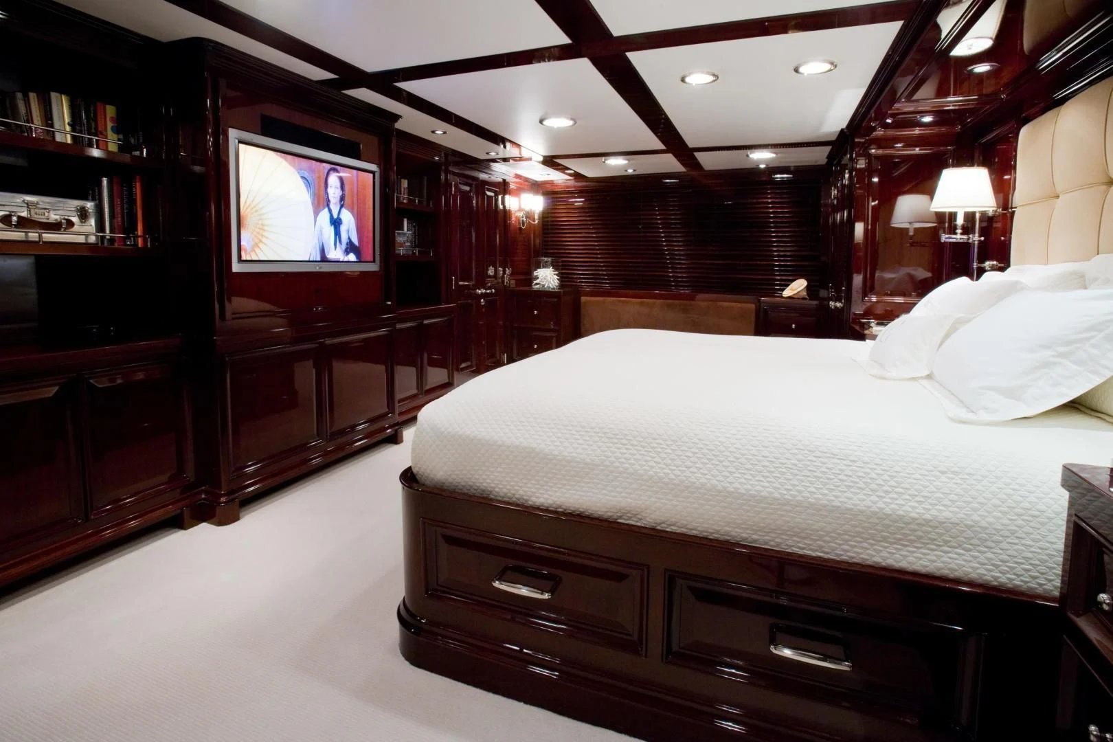 a room with a bed and a television aboard EXPLORA Yacht for Sale