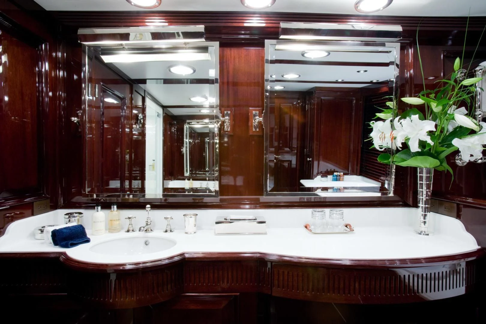 a bathroom with a large mirror aboard EXPLORA Yacht for Sale