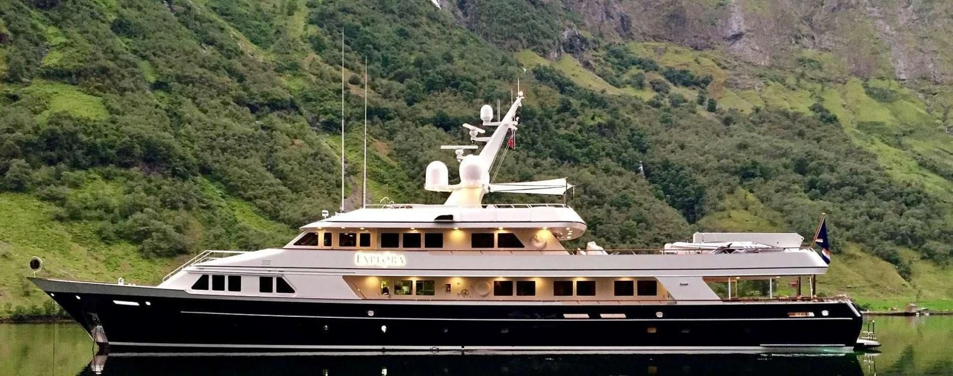 a large boat in a body of water aboard EXPLORA Yacht for Sale