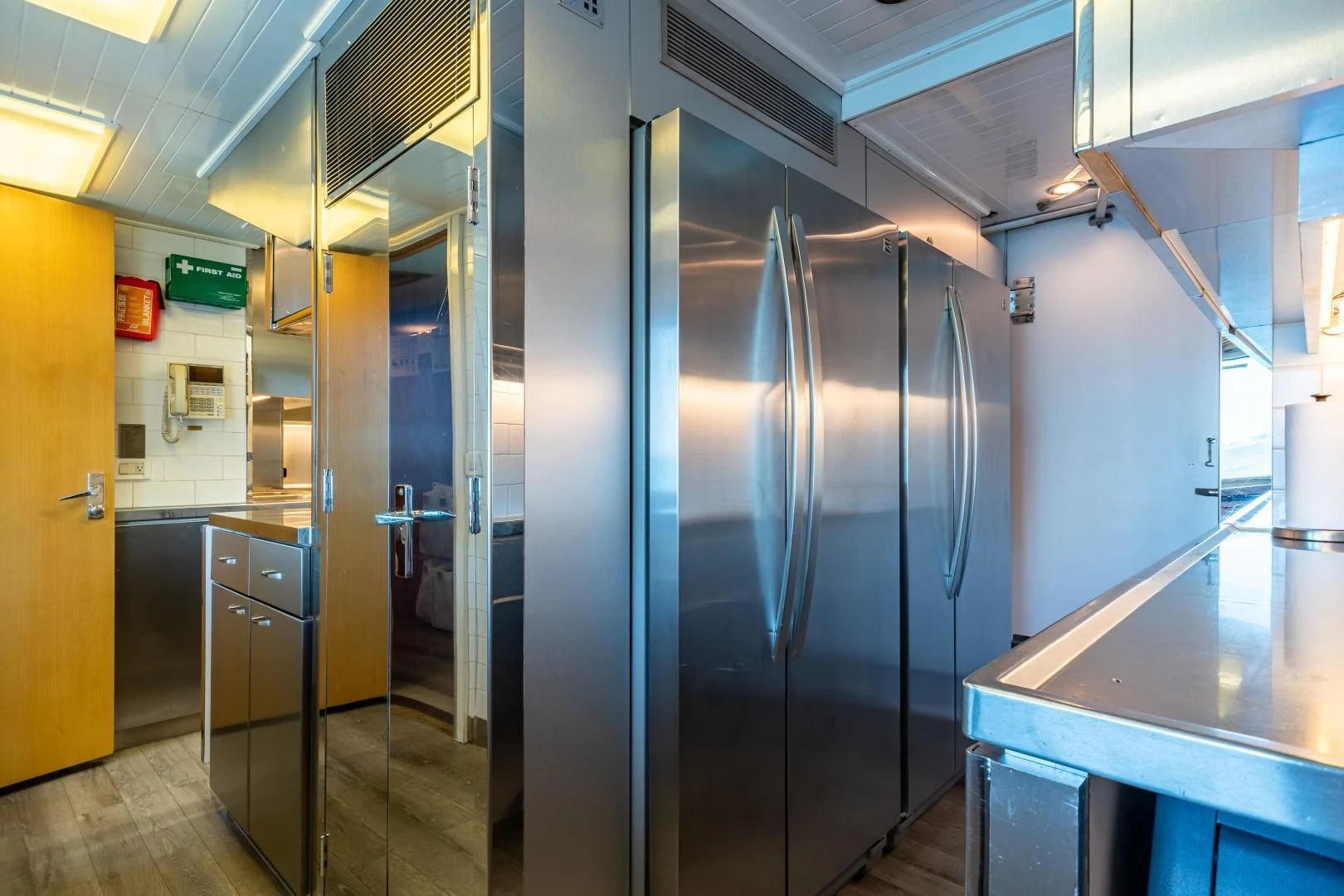 a room with a large stainless steel refrigerator and a counter aboard EXPLORA Yacht for Sale