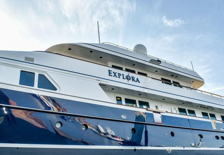 a large boat on the water aboard EXPLORA Yacht for Sale