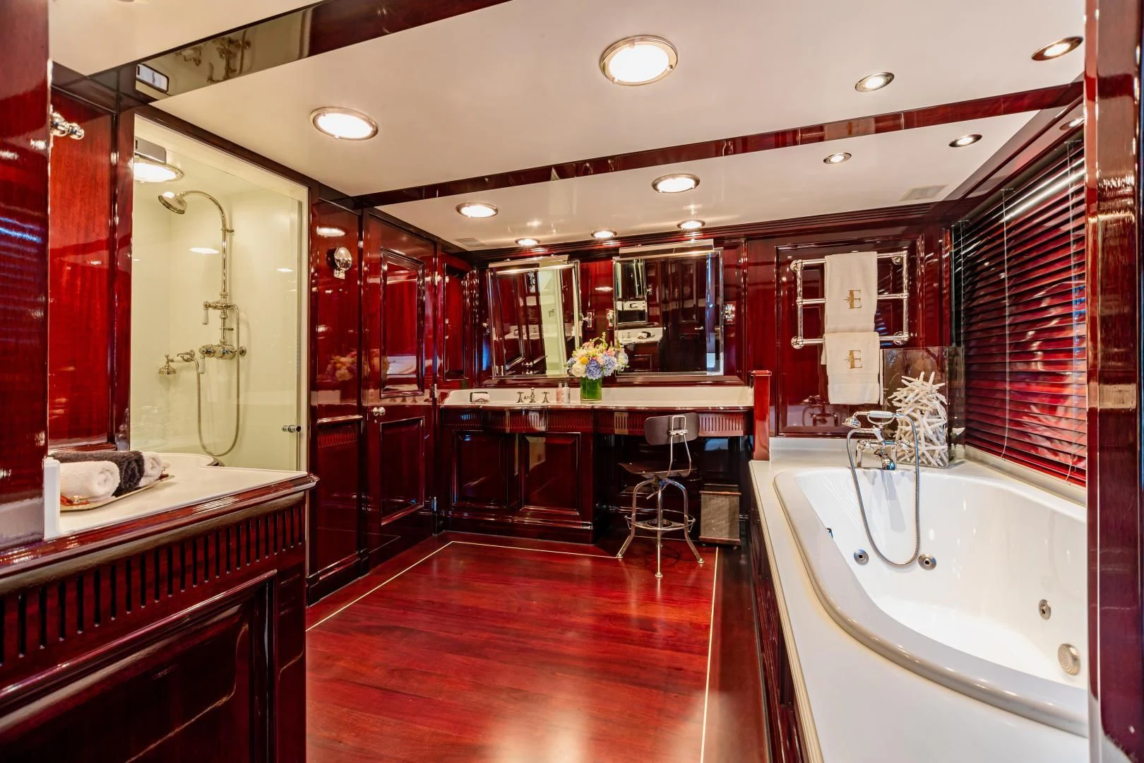 a bathroom with a tub and sink aboard EXPLORA Yacht for Sale