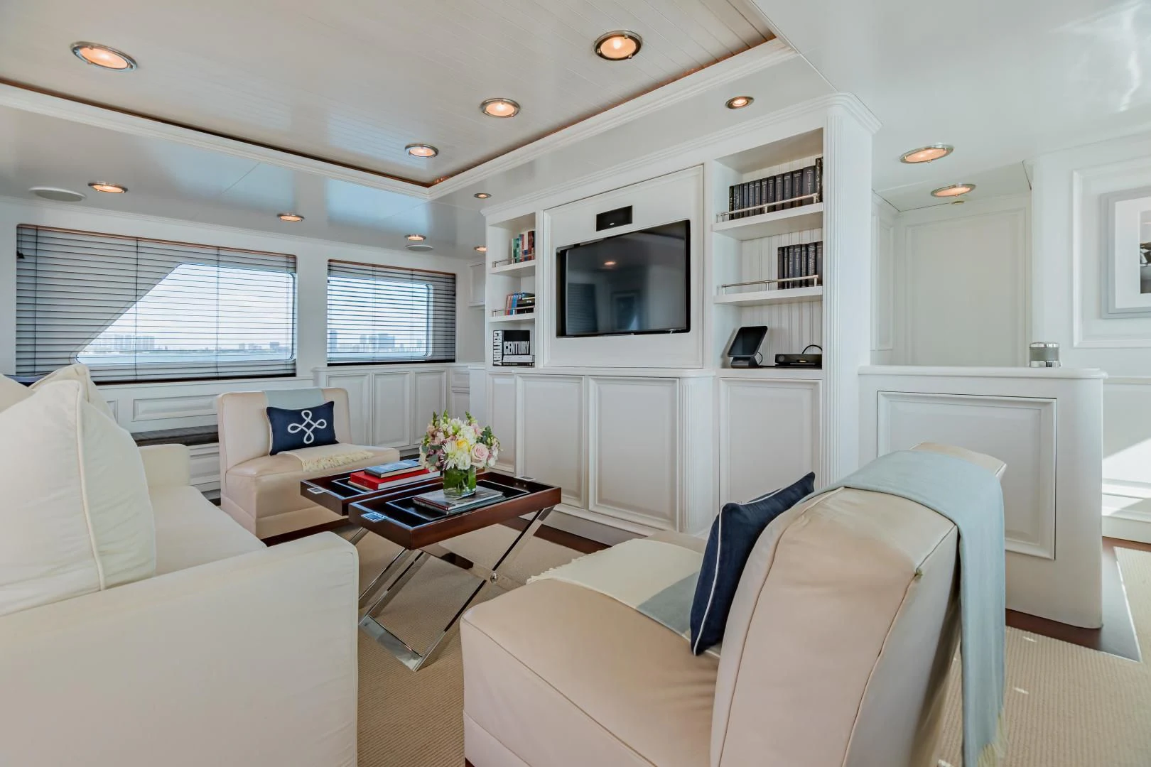 a living room with a couch and a television aboard EXPLORA Yacht for Sale