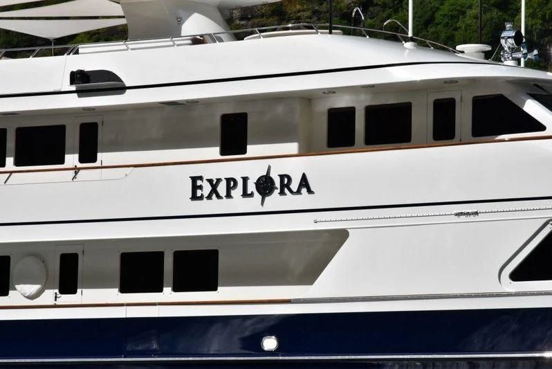 a white boat with black text aboard EXPLORA Yacht for Sale