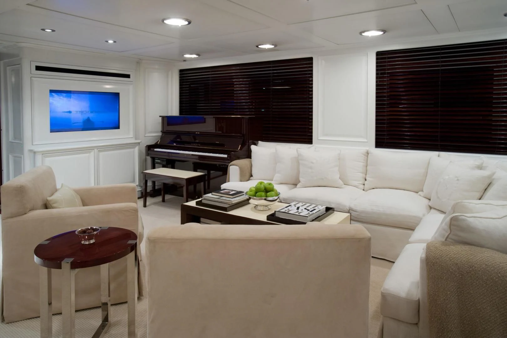 a living room with a couch and a tv aboard EXPLORA Yacht for Sale