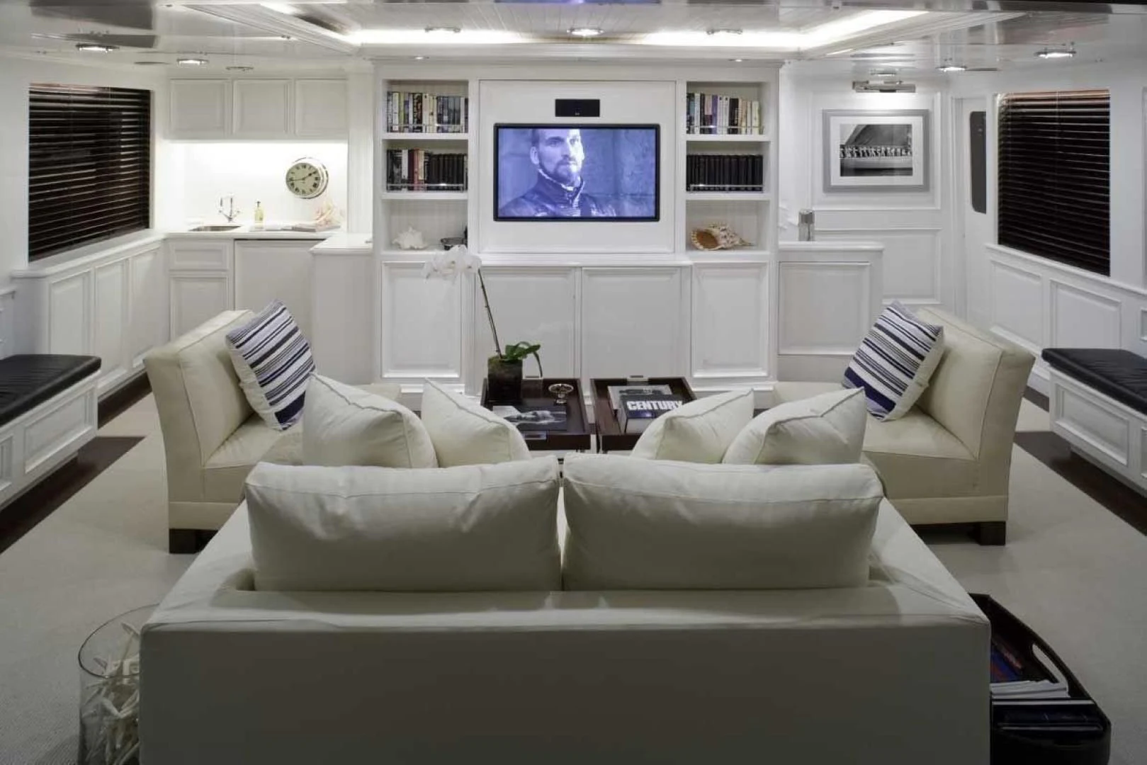 a living room with white furniture aboard EXPLORA Yacht for Sale