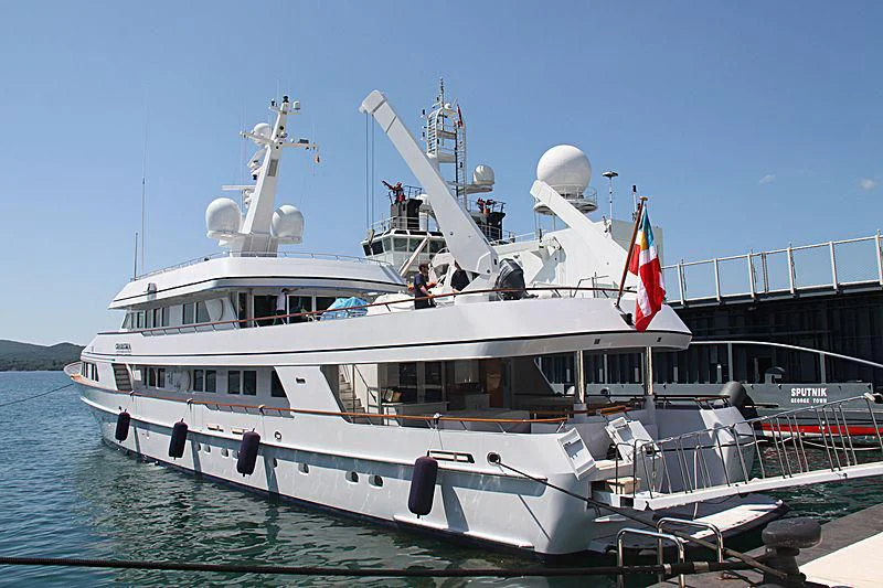 a large white boat with flags on it aboard EXPLORA Yacht for Sale