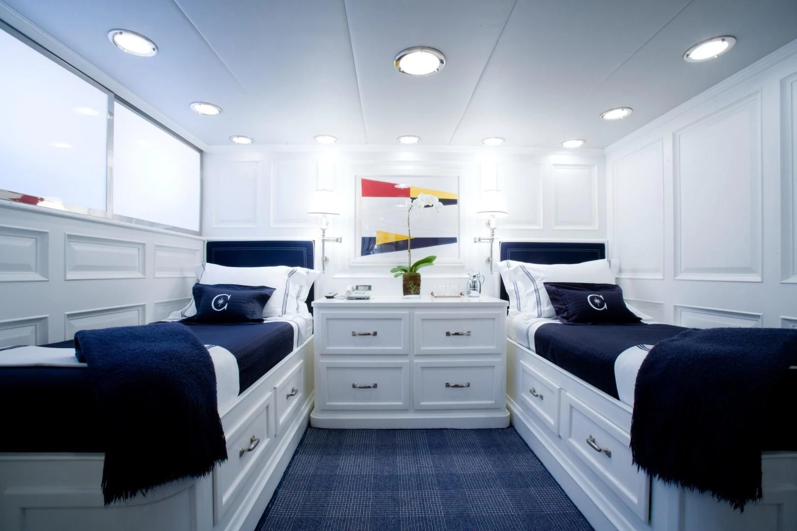 a bedroom with white cabinets aboard EXPLORA Yacht for Sale